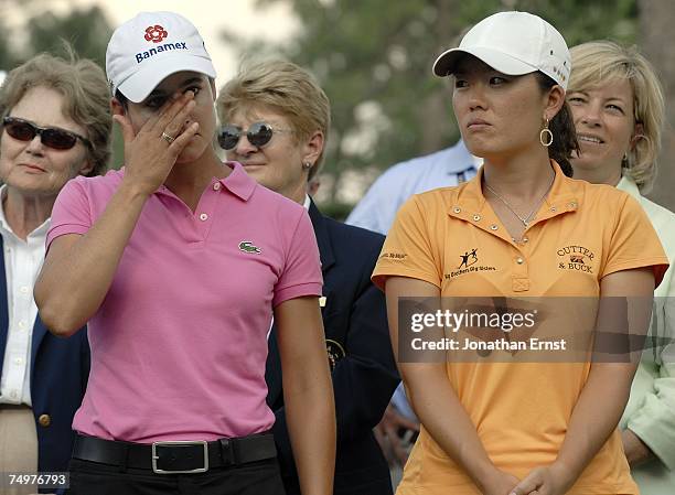 Lorena Ochoa of Mexico wipes her eyes as she and fellow runner-up Angela Park attend the trophy ceremony at the U.S. Women's Open Championship at...