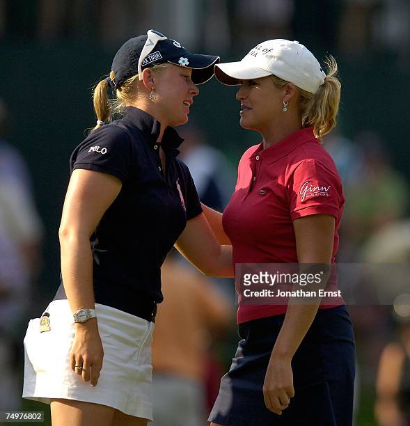Morgan Pressel hugs Cristie Kerr on the 18th green during the final round of the U.S. Women's Open Championship at Pine Needles Lodge & Golf Club on...