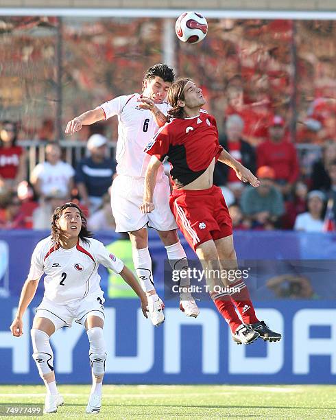 Andre Lombardo and Gary Medel of Chile go up for a header during a match between Canada's Under-20 Men's National Team and Chile's Under-20 Men's...