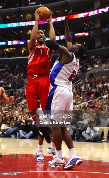 Tracy McGrady of the Houston Rockets shoots over Tim Thomas of the Los Angeles Clippers during 92-87 victory in NBA game at the Staples Center in Los...