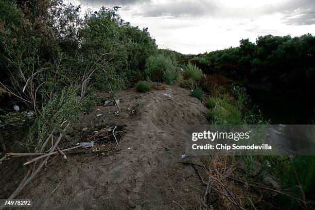 Makeshift camp sits on the banks of the Mexico side of the Rio Grande July 1, 2007 near Ciudad Juarez, Mexico. This area is a popular place for...