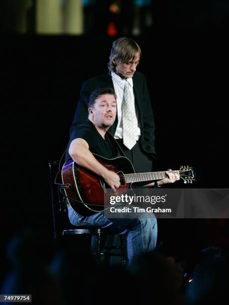 Comedian Ricky Gervais and actor Mackenzie Crook sing together on stage at the 'Concert for Diana' at Wembley Stadium which the Princes organised to...