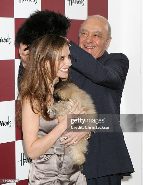Actress Sarah Michelle Geller and Mohammed Al-Fayed play around with dogs as they open the Harrod's Summer Sale on July 2, 2007 in London England.