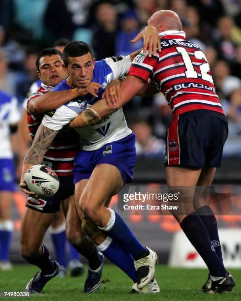 Sonny Bill Williams of the Bulldogs looks to pass while being tackled by Craig Wing and Craig Fitzgibbon of the Roosters during the round 16 NRL...