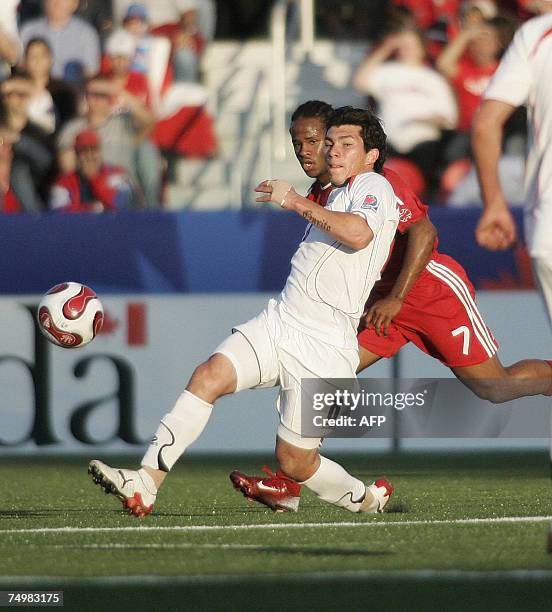 Chile's Gary Medel kicks the ball as Canada's Jaime Peters closes in during their FIFA U-20 match on 01 July 2007 in Toronto, Ontario, Canada. Chile...