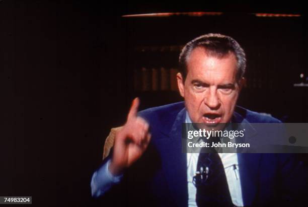 Screen capture of former American President Richard Milhous Nixon gestures emphatically during an interview on 'Frost On America,' a television...