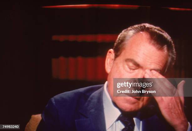 Screen capture of former American President Richard Milhous Nixon rubs his head during an interview on 'Frost On America,' a television program...