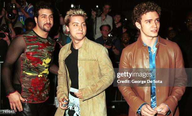 Singer Joey Fatone, Jr., singer Lance Bass and singer Justin Timberlake of the pop group N'sync pose for photographers July 31, 2000 at the premiere...