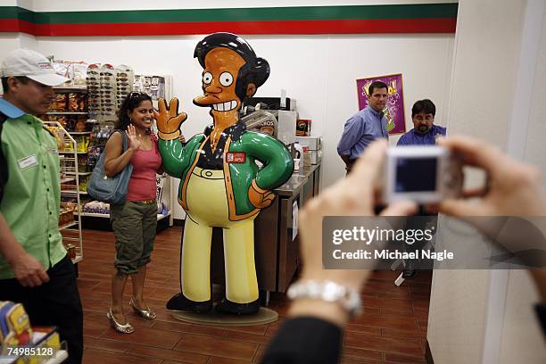 Shelly Ramsammy poses with a representation of "Apu," fictional owner of the Kwik-E-Mart from the long-running televsion cartoon show "The Simpsons"...