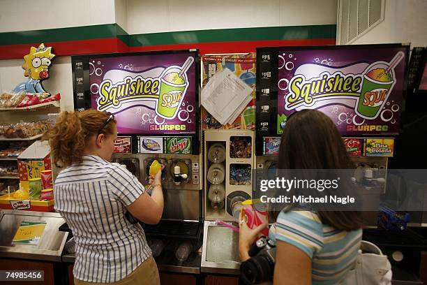 Mehgan Belanger and Tammy Mastrobrete, of "Convenience Store News" magazine, pour themselves Squishees, the Slurpee-like concoction made famous on...