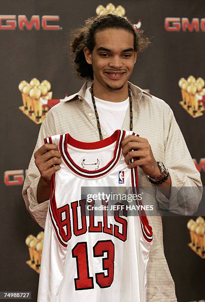 Deerfield, UNITED STATES: Joakim Noah, the first round draft pick of the Chicago Bulls, holds his jersey 02 July, 2007 at the Chicago Bulls Berto...