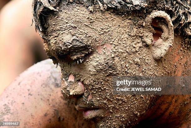 Jakarta, Java, INDONESIA: An environmental activist covered with mud takes part in a demonstration against Lapindo Brantas, a company linked to...
