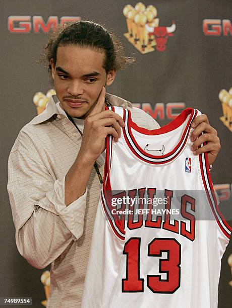 Deerfield, UNITED STATES: Joakim Noah, the first round draft pick of the Chicago Bulls, holds his jersey 02 July, 2007 at the Chicago Bulls Berto...