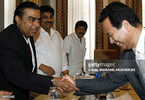 Chairman of India's biggest private company, Reliance Industries, Mukesh Ambani greets Japanese Minister of Economy, Trade and Industry, Akira Amari...