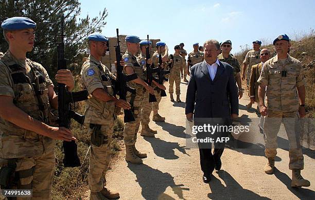 Belgian UN peacekeeping soldiers salute Belgian Defence Minister Andre Flahaut during his visit to their camp in the southern Lebanese village of...