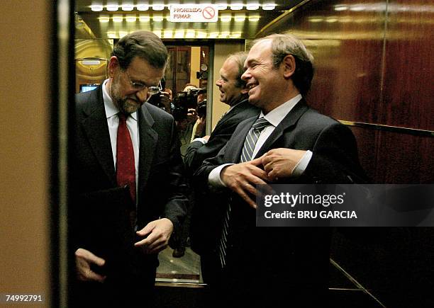 Spanish opposition Popular Party leader Mariano Rajoy chats with Madrid?s Popular party president Pio Garcia Escudero as they arrive at the...