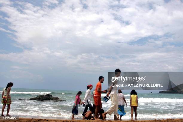 Algerians walk on the beach near Tipaza, 70 km west of Algiers, 03 July 2007. AFP PHOTO / Fayez NURELDINE