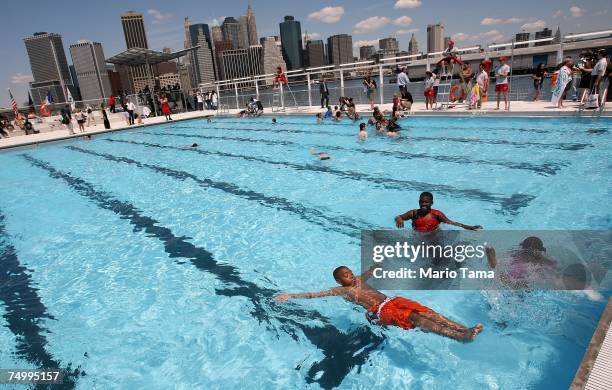 Children swim in a new floating pool dubbed the 'Floating Pool Lady' following a press conference announcing its opening July 3, 2007 in the Brooklyn...