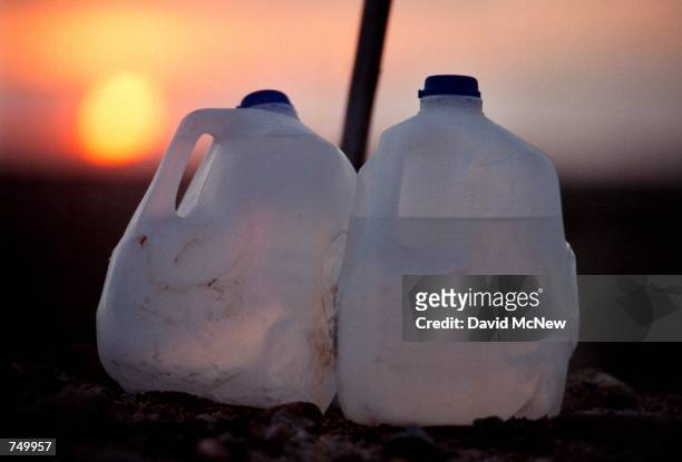 The sun rises behind water bottles at a water station for illegal immigrants July 29, 2000 near the U.S./Mexico border in the Yuha Desert west of...
