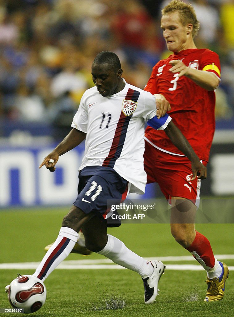 Freddy Adu (L) of the US gets past Polan...