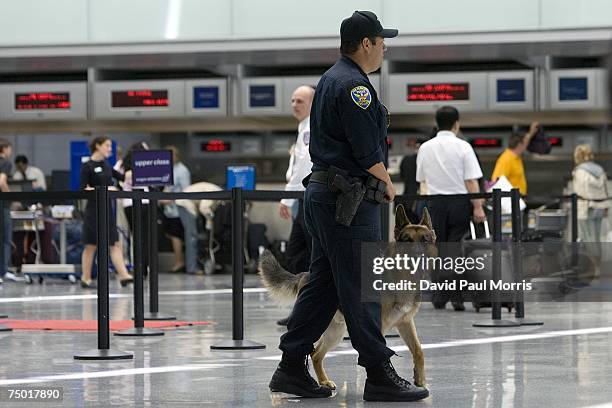 San Francisco police officer Carlos Cordova and his dog Fax patrol the ticketing area of the International Terminal at the San Francisco...