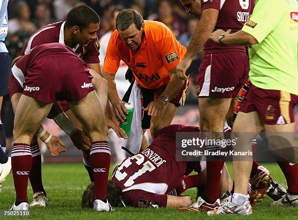 Dallas Johnson of the Maroons lays injured on the ground during game three of the State of Origin series between the Queensland Maroons and the New...