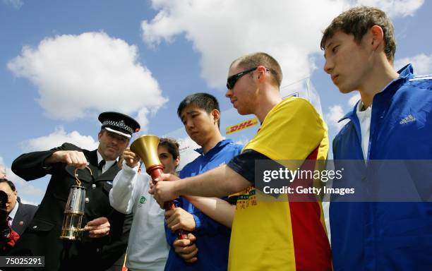 Tim Madgwick, Chairman of the Torch Run lights the tourch during the DHL-Special Olympics Torch run 'Flame of Hope', on July 4, 2007 in London,...