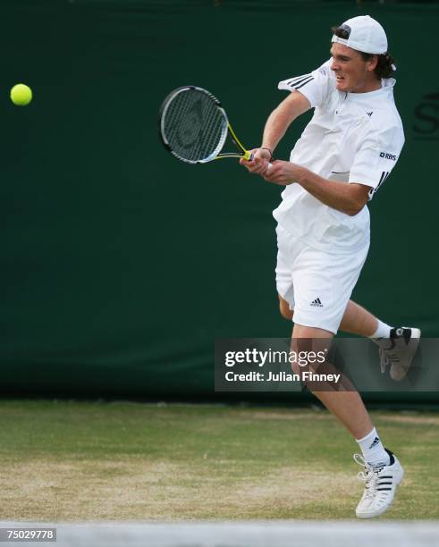 Jamie Murray of Great Britain plays a backhand during the Mixed Doubles first round match against Richard Bloomfield of Great Britain and Sarah...