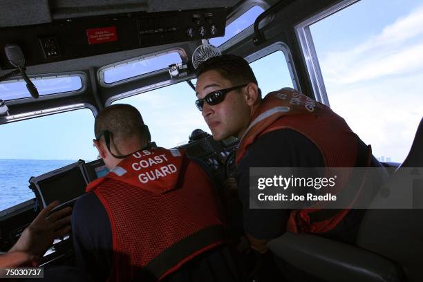 United States Coast Guard officer Michael Rivera patrols in the water off of Port Everglades July 4, 2007 in Fort Lauderdale, Florida. Across the...