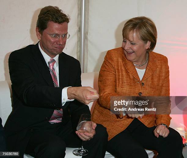 German Chancellor Angela Merkel and Guido Westerwelle of the German Free Democrats attend the BILD and BAMS summer reception on July 4, 2007 in...