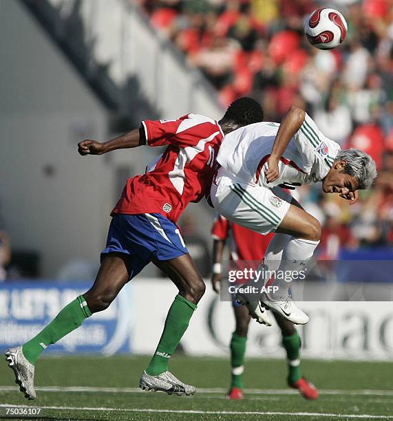 Mexico's Carlos Vela and Gambia's Ebrima Sohna fight for position during the second half of their FIFA U-20 World Cup match 02 July 2007 in Toronto,...