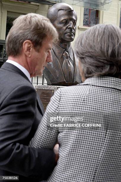 French Foreign Minister Bernard Kouchner speaks with Annie de Mello 05 July 2007 in front of a bust of late High Commissioner for Human Rights,...