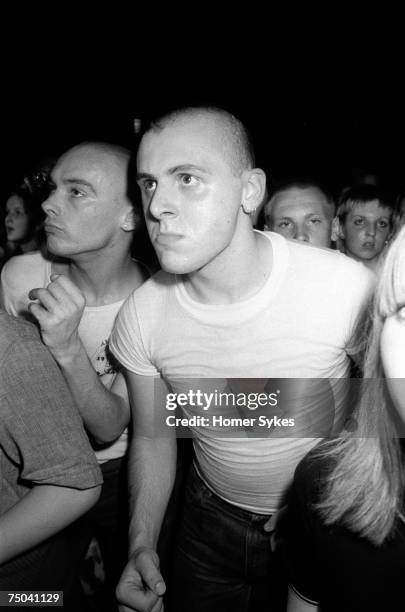 Skinheads dancing to UB40 at the Electric Ballroom nightclub in Camden, 1980. Hospital porter Jimmy John lives in Whitechapel.