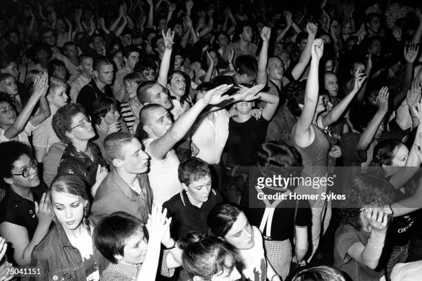 Skinheads dancing to UB40 at the Electric Ballroom nightclub in Camden, 1980. Hospital porter Jimmy John gives the Nazi salute although he is not a...