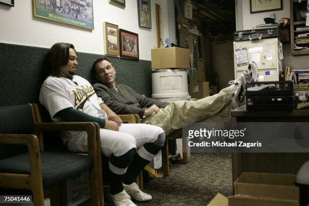 General Manager Billy Beane and Nick Swisher of the Oakland Athletics talk in the clubhouse before the game against the San Francisco Giants at the...