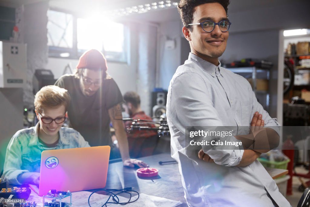 Portrait smiling, confident male designer in workshop