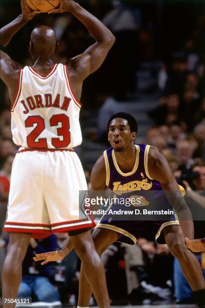 Kobe Bryant of the Los Angeles Lakers digs in on defense against Michael Jordan of the Chicago Bulls during a 1998 NBA game at the United Center in...