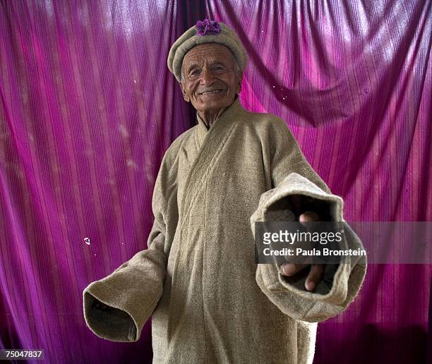 Mughal Khan who will turn 100 in October, shows off his traditional Hunza woolen cape July 1, 2007 in Altit, Hunza Valley, Pakistan. Mughal was born...