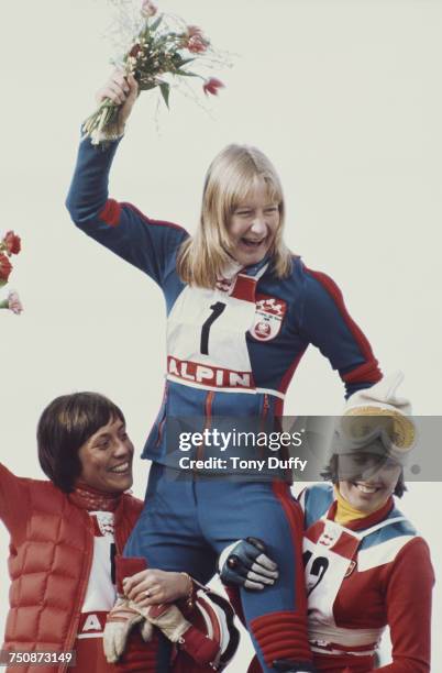 Kathy Kreiner of Canada celebrates with second placed Rosi Mittermaier of Germany and Daniele Debernard of France after winning the Women's Giant...