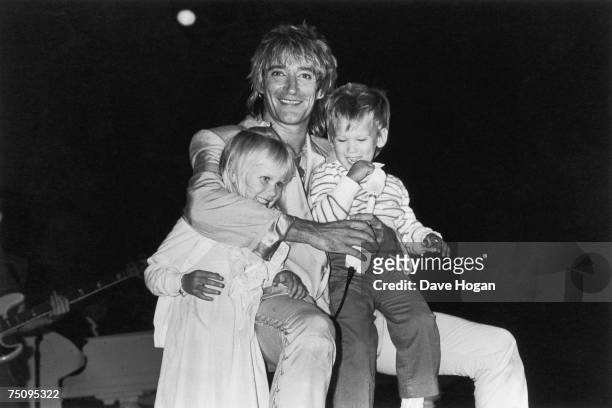 English rock and pop singer-songwriter Rod Stewart with his children Kimberly and Sean, 1983.