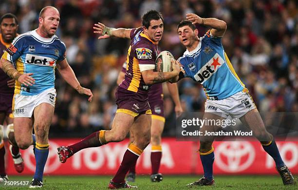 Corey Parker of the Broncos avoids the Titans defence during the round 17 NRL match between the Brisbane Broncos and the Gold Coast Titans at Suncorp...