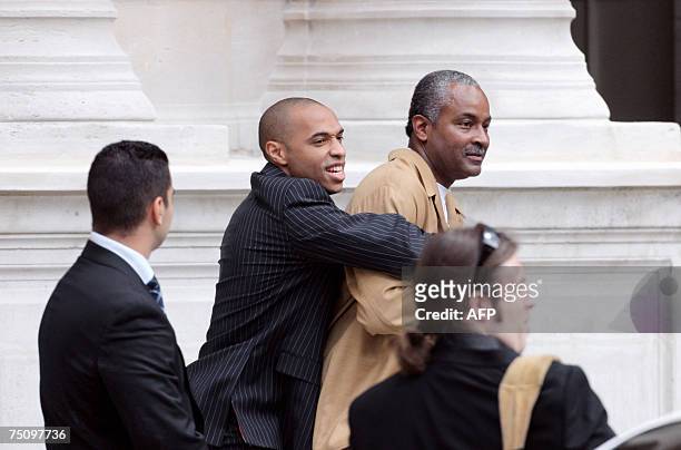 Superstar Tony Parker's father jokes with French football international player Thierry Henry as they arrive to attend the "Desesperate Housewives"...