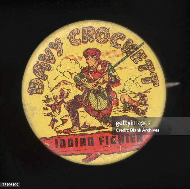 Round button, labelled 'Davy Crockett, Indian Fighter' and advertising a television program of the same name, rshows a profile portrait of the...