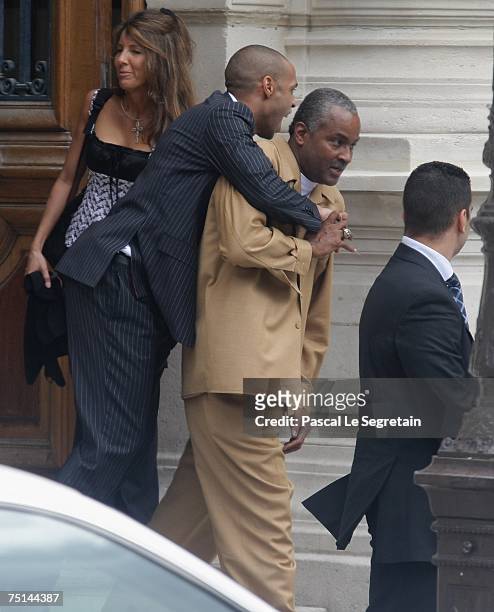 French Football player Thierry Henri jumps on Tony Parker's father as they leave Paris town hall after the wedding between Eva Longoria and Tony...
