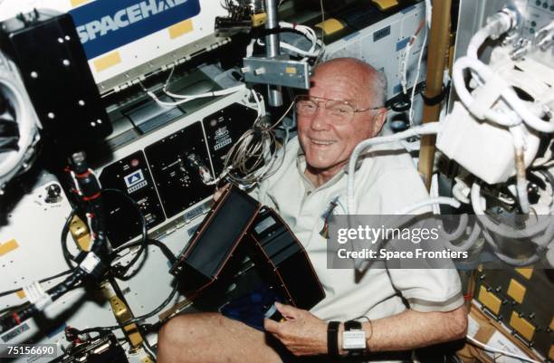 American astronaut John Glenn becomes the oldest person in space during the STS-95 mission on board the shuttle Discovery, 1998.