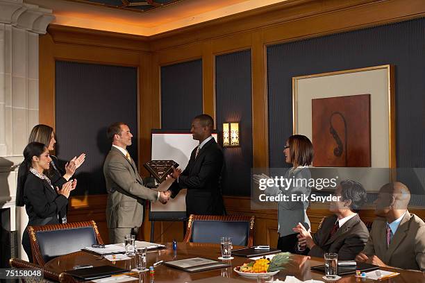 business people in conference room, business men receiving award while colleagues applaud - receiving award stock pictures, royalty-free photos & images