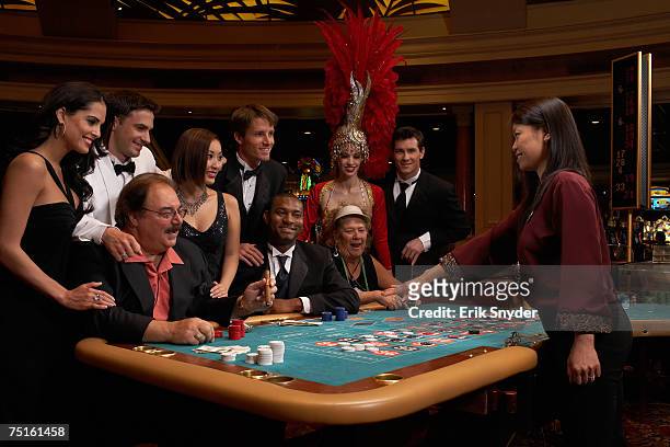 group of people playing roulette - casino dealer stockfoto's en -beelden