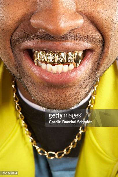 portrait of young man with gold teeth, close-up - bling bling stock pictures, royalty-free photos & images