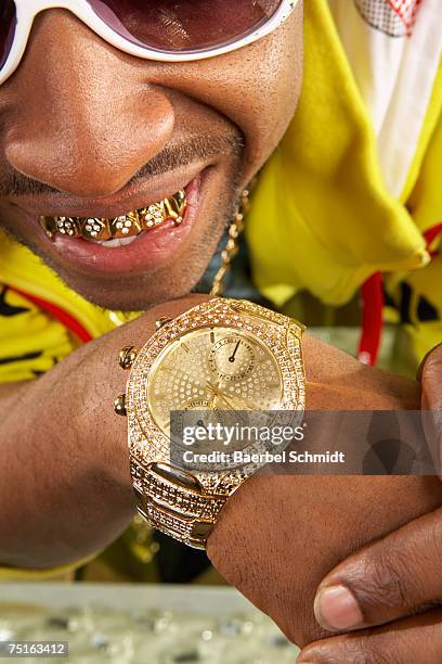 young man with gold teeth and watch, close-up - black bling stock pictures, royalty-free photos & images