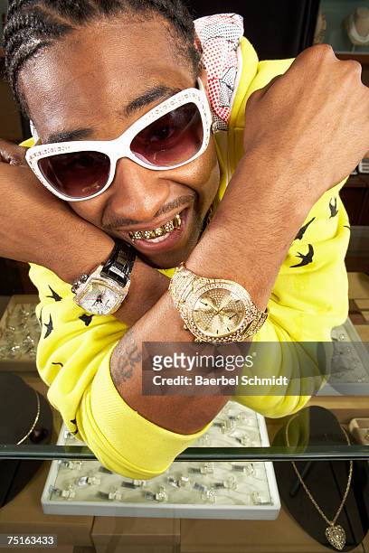 young man with gold teeth and watches, close-up - capped tooth stock-fotos und bilder